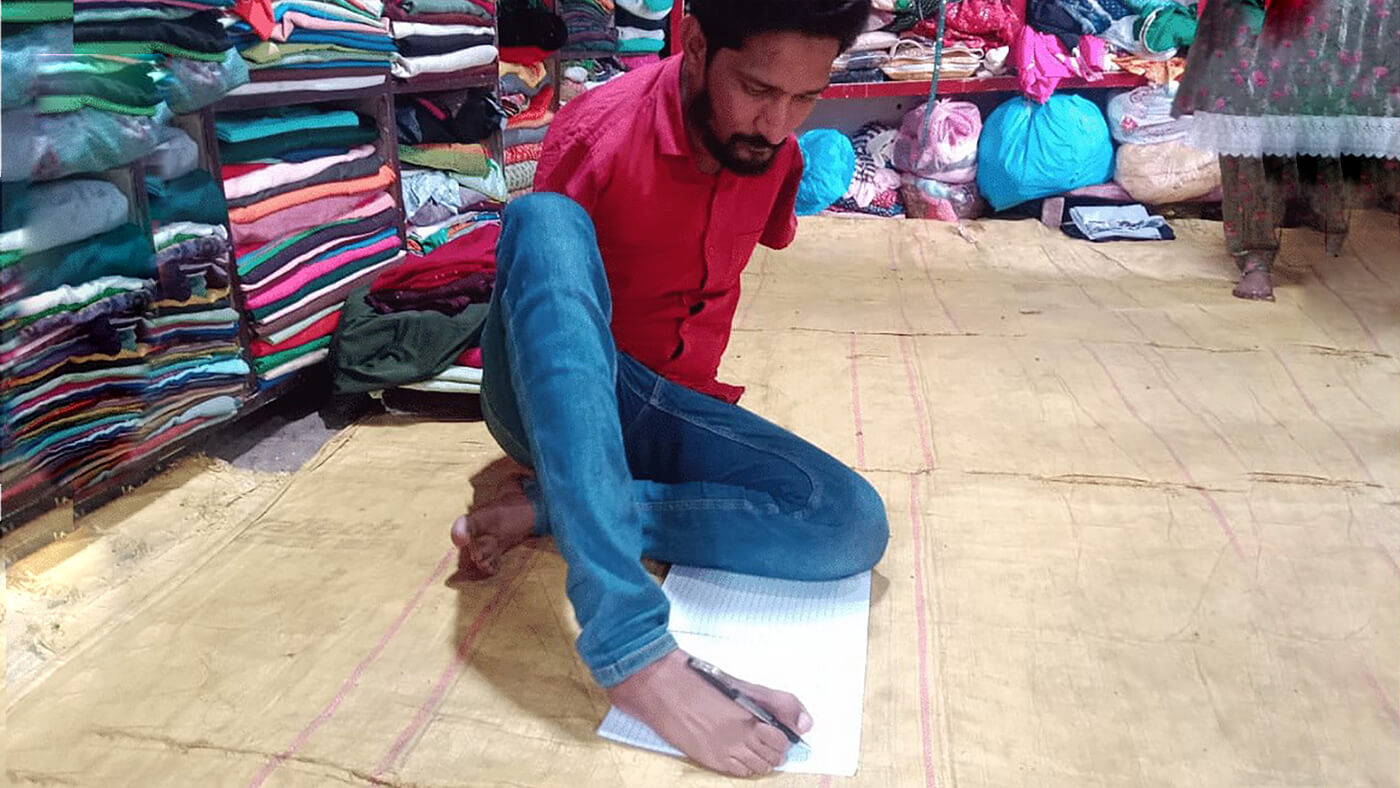 Born without hands, Amin scripts success with feet, qualifies to be patwari